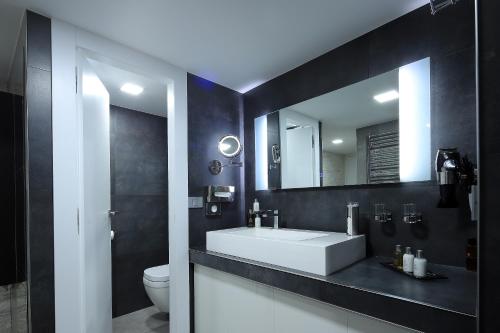 a bathroom with a white sink and a mirror at RedRose Piran in Piran