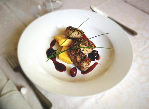a white plate with food on a table at Šiker B&B Hotel in Pernica