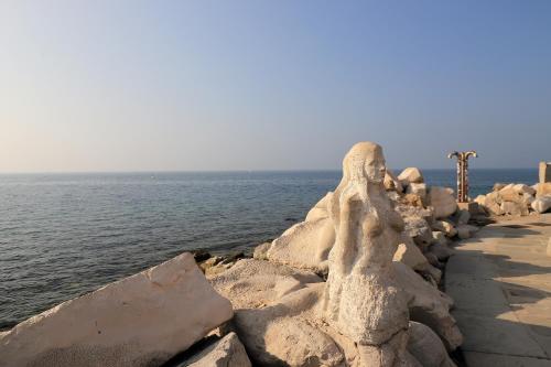 a rock wall next to a body of water at RedRose Piran in Piran