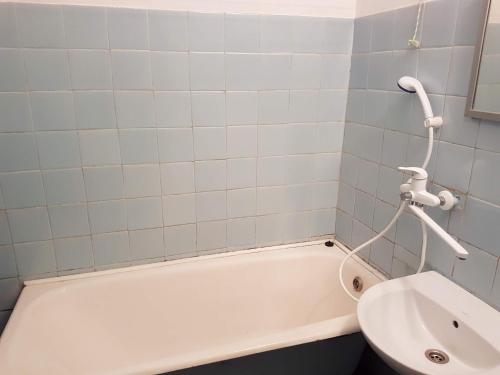 a bathroom with a white tub and a sink at Apartment on Y. Mudroho 44 in Bila Tserkva