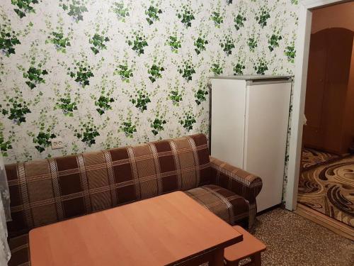 a living room with a couch and a refrigerator at Apartment on Y. Mudroho 44 in Bila Tserkva