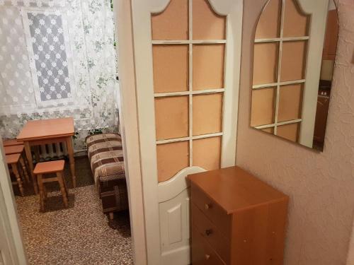 a room with a closet with a mirror and a table at Apartment on Y. Mudroho 44 in Bila Tserkva