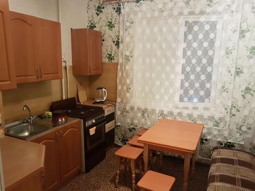 a kitchen with a stove and a sink and a window at Apartment on Y. Mudroho 44 in Bila Tserkva
