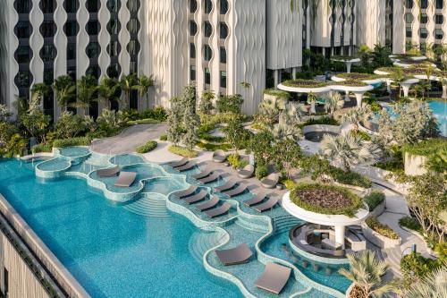 an aerial view of a resort pool with lounge chairs at Village Hotel Sentosa by Far East Hospitality in Singapore