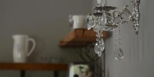 a chandelier hanging from the ceiling in a room at Dancing River Guesthouse in Vereeniging