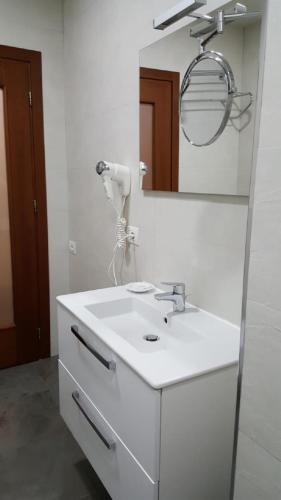 a bathroom with a white sink and a mirror at La Bohème Hotel in Tirana