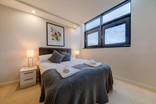 a bedroom with a bed with two towels on it at Cleyro Serviced Apartments - Finzels Reach in Bristol