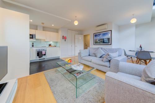 a living room with a couch and a table at Cleyro Serviced Apartments - Finzels Reach in Bristol