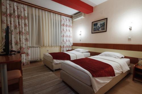 a hotel room with two beds in a room at Hotel Ilinden in Strumica