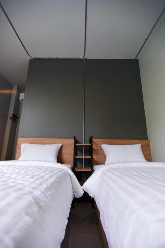 two beds sitting next to each other in a room at Bed garden 26 in Bangkok