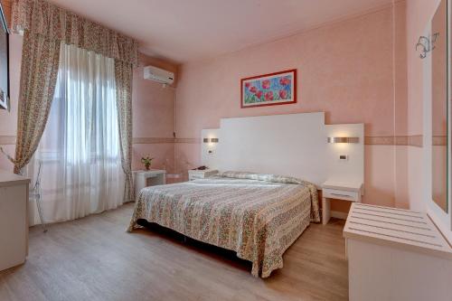 Habitación de hotel con cama y ventana en Hotel Massimo d'Azeglio en Montecatini Terme