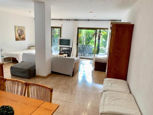 a living room with a couch and a bed and a television at APARTAMENTO - WIFI FREE - FRENTE AL MAR in Salou