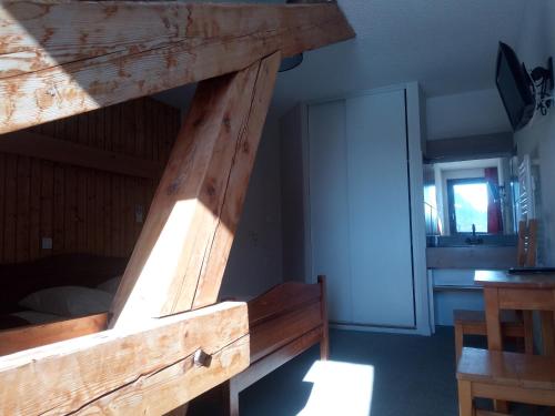 a loft bed in a room with a door at Espace Morteau in Morteau