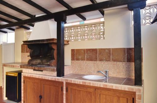 a kitchen with a stove and a sink at Seaside House Morrojable La Ilusión in Morro del Jable