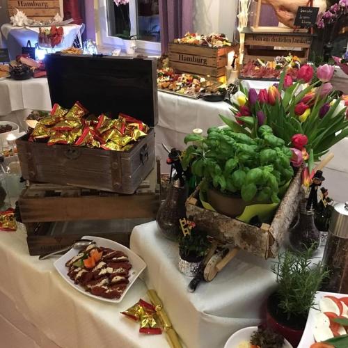 a table topped with white tables with food and flowers at Parkhotel Meerane in Meerane