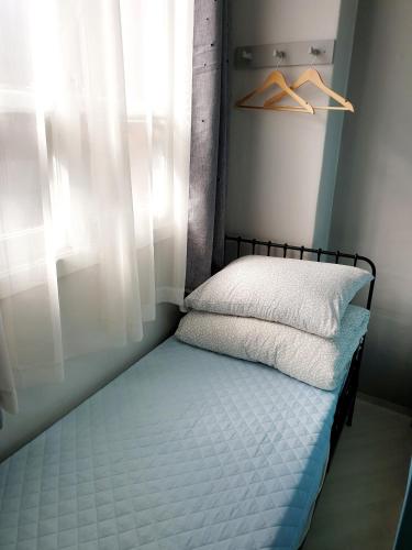 a small bed in a room with a window at Y.ROAD 135 in Seoul