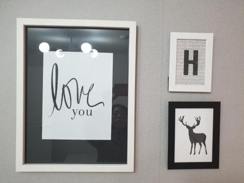 a picture frame with a thank you sign on a wall with pictures at Y.ROAD 135 in Seoul