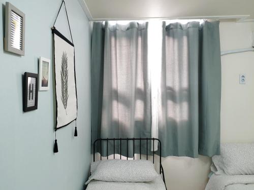 a bedroom with a crib and a window at Y.ROAD 135 in Seoul