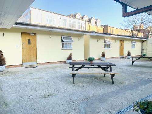 a picnic table in front of a building at Britannia Inn Hotel in Ilford