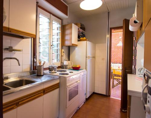 a kitchen with a sink and a stove at THE BOUCAMVIGLIA BEACH HOUSE in Saronida