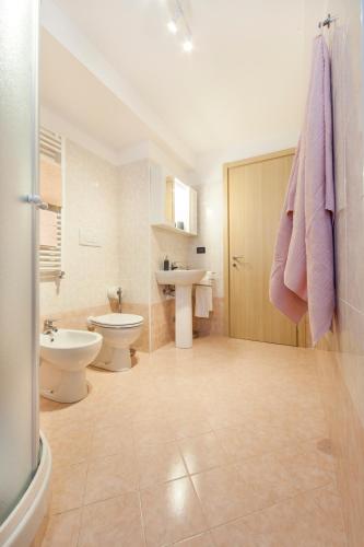 a bathroom with a toilet and a sink and a shower at Narciso Centralissimo in Sanremo