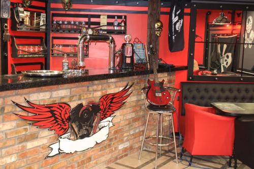 a bar with a brick wall with a guitar on it at Biker's Pub in Oleksandriya