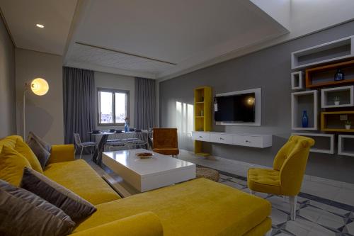 a living room with a yellow couch and a table at BnB MEDINA in Marrakech