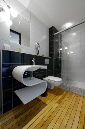a bathroom with a sink and a toilet and a shower at La Bonne Auberge in Clerval