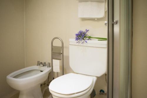 a white bathroom with a toilet and a sink at Apartment W Stunning View - MARINA - Free Parking & AC in Funchal