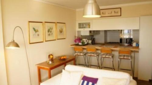 a kitchen with a white couch in a room at Apartment W Stunning View - MARINA - Free Parking & AC in Funchal