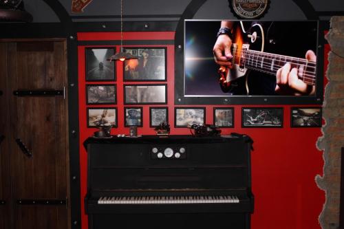 a room with a guitar and a piano and pictures at Biker's Pub in Oleksandriya