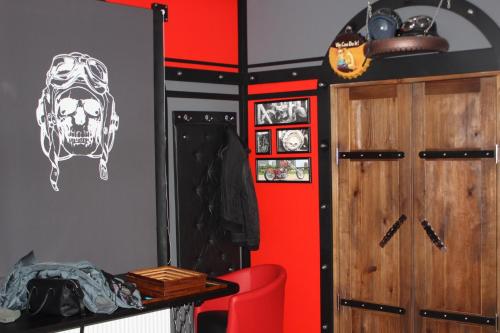a room with a red wall with a skull on the wall at Biker's Pub in Oleksandriya
