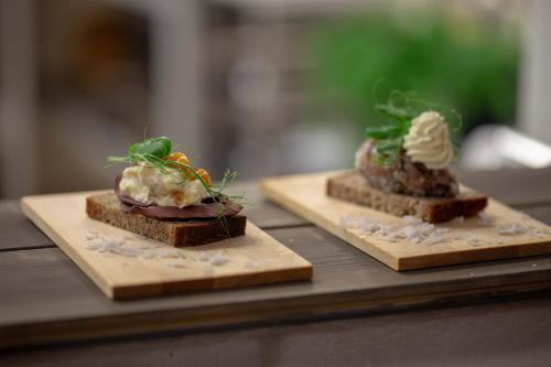 two pieces of bread with different types of food on them at Ammarnäs Wärdshus in Ammarnäs