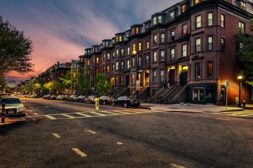 a city street with cars parked in front of buildings at Stylish Downtown Studio in the South End, C. Ave #1 in Boston