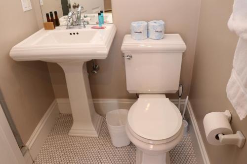 a bathroom with a white toilet and a sink at Stylish Downtown Studio in the South End, C. Ave #1 in Boston