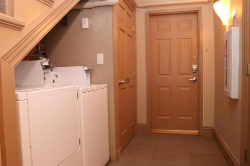 a small laundry room with a washer and dryer at Stylish Downtown Studio in the South End, C. Ave #1 in Boston