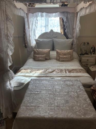 a bedroom with a bed with a canopy at Jasmine House in Newquay