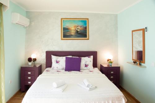 a bedroom with a large bed with two night stands at Apartments Ivona in Sveti Stefan