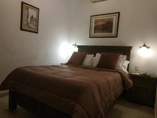 a bedroom with a large bed with two lamps at Casa India Catalina in Cartagena de Indias