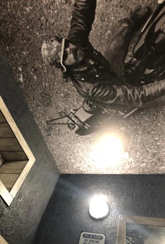 a person sitting on the floor with their feet on the ground at Biker's Pub in Oleksandriya