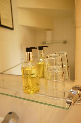 a shelf with three bottles of oil on it at Regency Hotel in Brighton & Hove