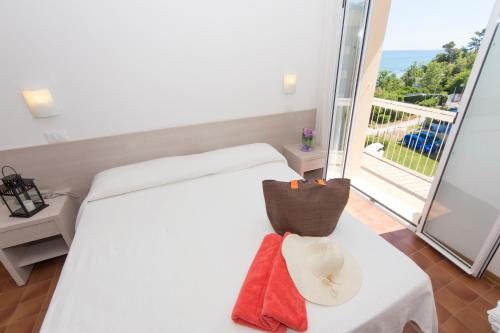 a hotel room with a bed and a balcony at Hotel Adler in Gabicce Mare