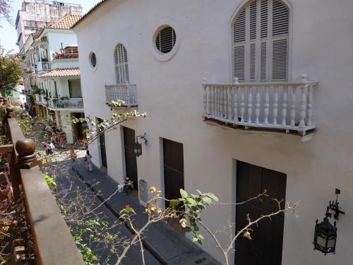 a white building with a staircase and a balcony at Casa India Catalina in Cartagena de Indias