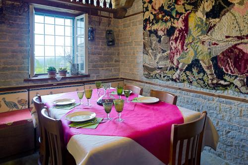 a table in a restaurant with a pink table cloth at Thoukididis in Kapesovo