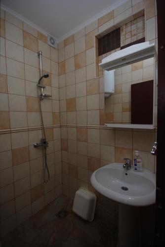 a bathroom with a sink and a shower at Apartments Astel in Bar