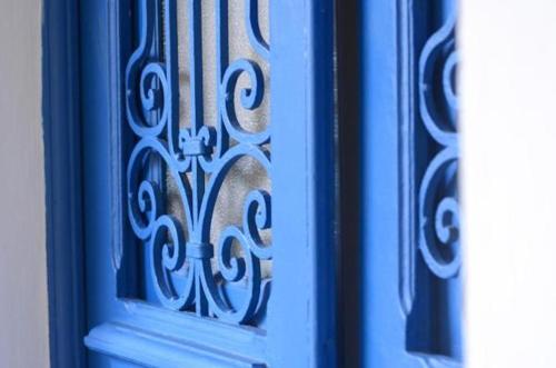 a blue door with a metal design on it at Brasileranza Hostel in Niterói