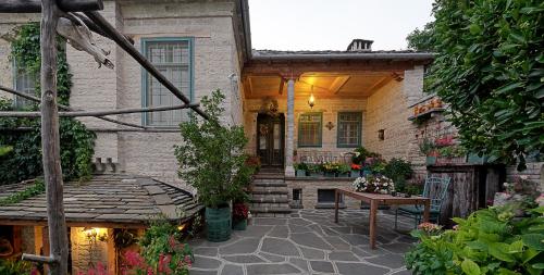 a house with a patio and a table in front of it at Thoukididis in Kapesovo