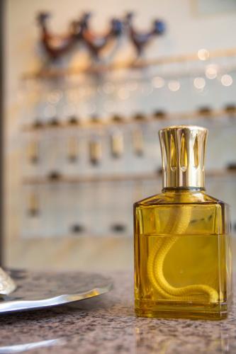 a bottle of yellow oil sitting on a table at Hotel Adler in Gabicce Mare