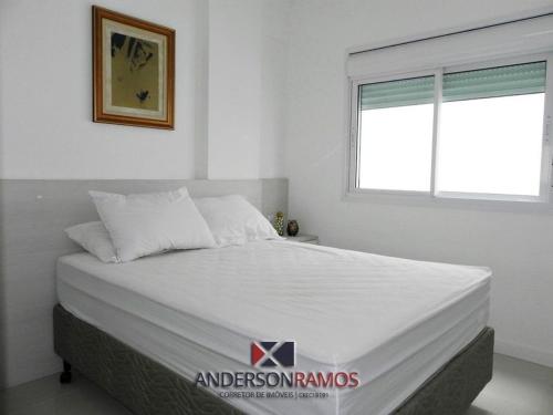 1 dormitorio con 1 cama grande y ventana en 1057 - Apartamento para locação em Bombinhas, en Bombinhas