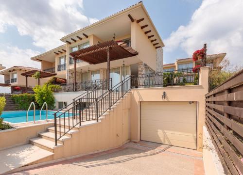a house with a garage and a swimming pool at Coral Luxury Villas in Lozenets